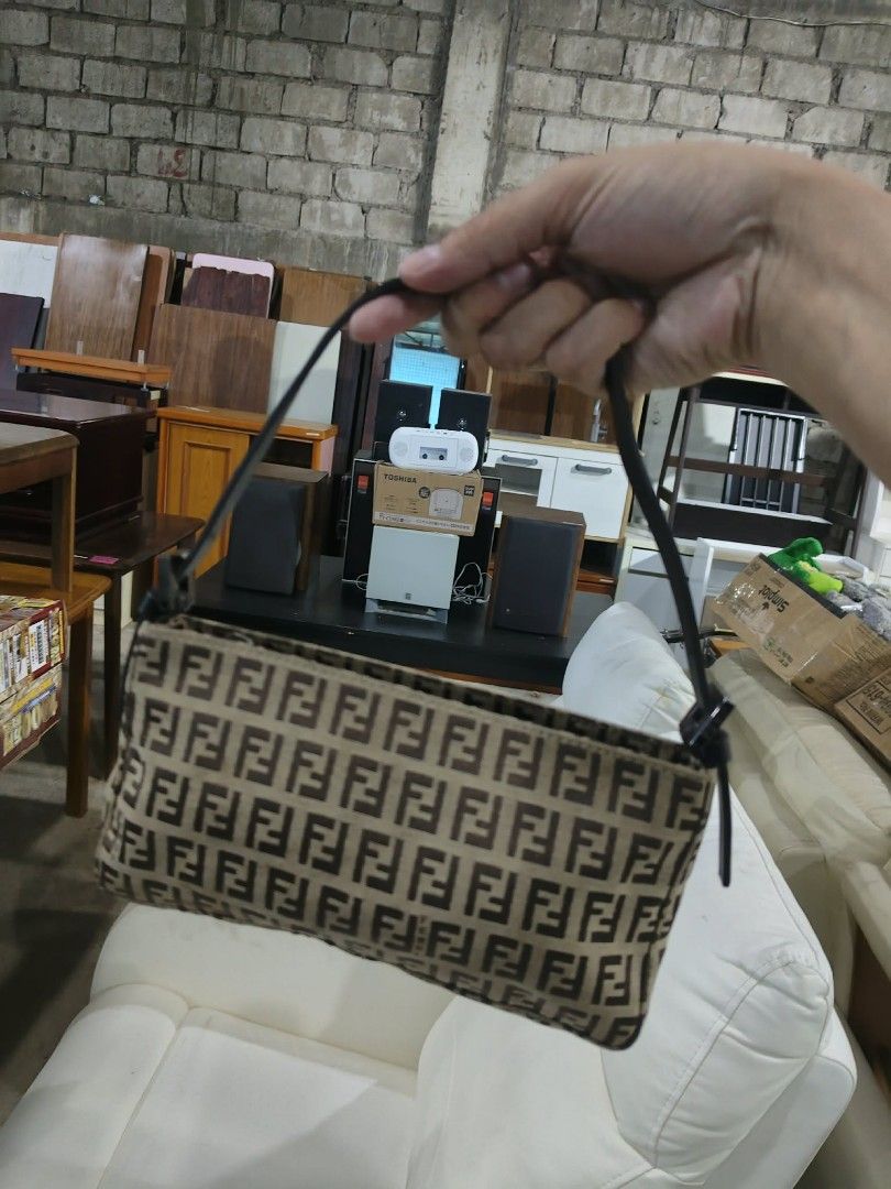 Fendi Zucca Canvas Mini Baguette Shoulder Bag (Category: Luxury Bags & Wallets) located in Gapan. Submitted by cleverstar.36492b (Listing ID 1458183089, Image 1). Description: Authentic Fendi mini baguette bag. Classic Zucca canvas pattern. Zipper closure. Interior has a small tag with serial number 2255.8BR144.029. Made in Italy. Small and compact, great for essentials. Handle is black leather..