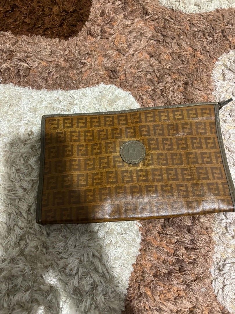 Fendi Zucca Monogram Pouch Clutch (Category: Luxury Bags & Wallets) located in Daet. Submitted by jemotovlog28 (Listing ID 1458222690, Image 3). Description: - Authentic vintage Fendi pouch - Classic Zucca monogram pattern (brown/tan) - Genuine leather trim and zipper - Interior zippered pocket for organization - Versatile: use for essentials or as a clutch.
