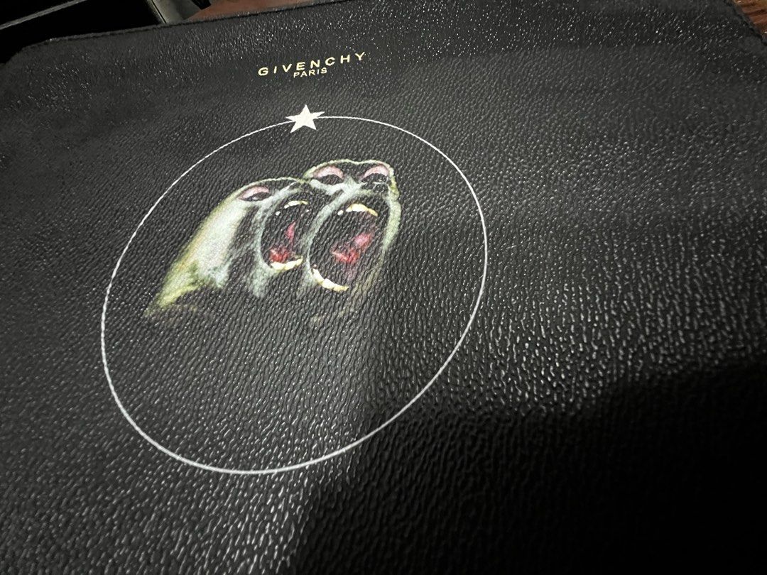 Givenchy Black Leather Monkey Print Pouch (Category: Purses & Pouches) located in Dasmarinas. Submitted by corruptdot (Listing ID 1458204785, Image 3). Description: - Authentic Givenchy black leather pouch - Features the iconic monkey print - Ideal for carrying your daily essentials - Clean and well-maintained interior - Secure zipper closure - A stylish and versatile accessory.