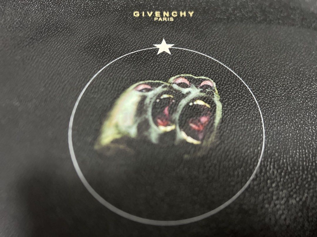 Givenchy Black Leather Monkey Print Pouch (Category: Purses & Pouches) located in Dasmarinas. Submitted by corruptdot (Listing ID 1458204785, Image 1). Description: - Authentic Givenchy black leather pouch - Features the iconic monkey print - Ideal for carrying your daily essentials - Clean and well-maintained interior - Secure zipper closure - A stylish and versatile accessory.