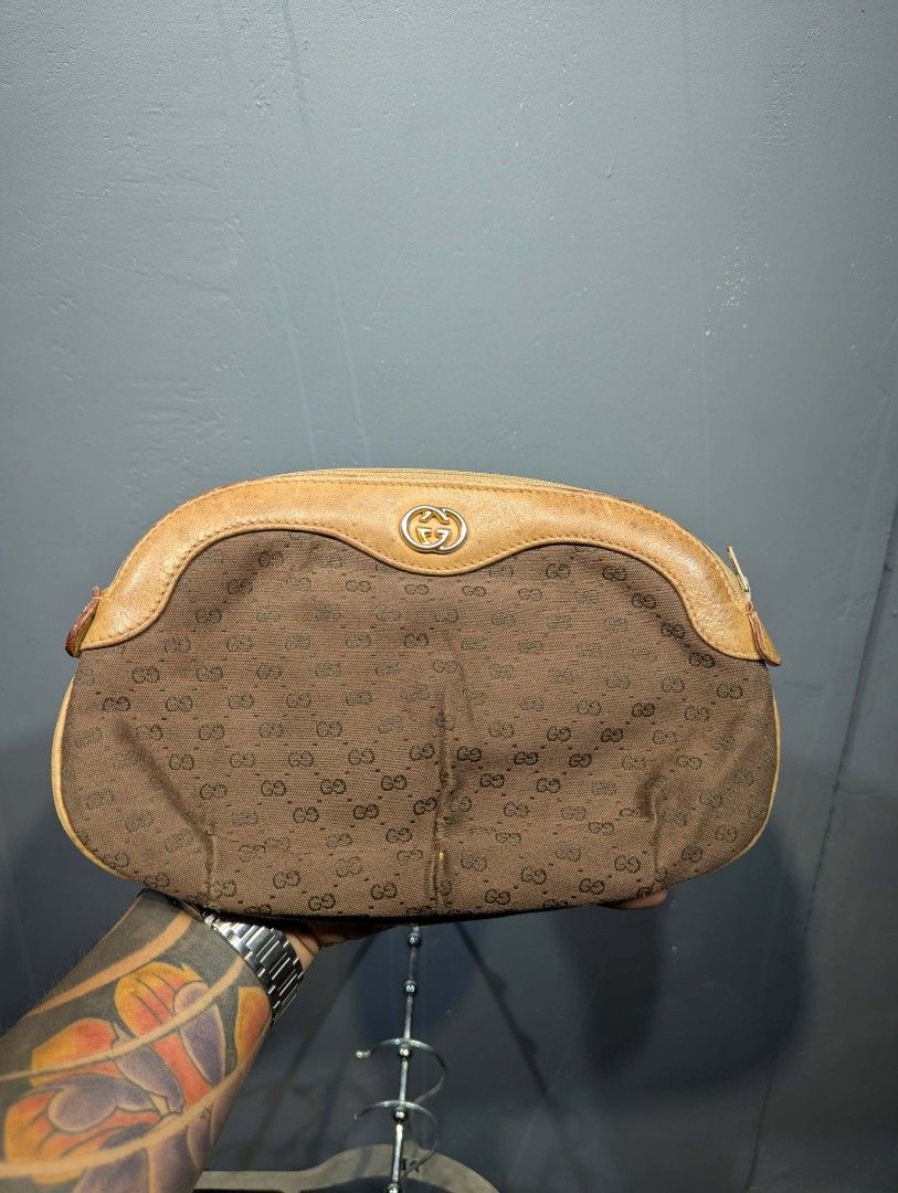 Gucci Monogram Clutch Bag (Category: Luxury Bags & Wallets) located in Manila. Submitted by roblesniks33584 (Listing ID 1458255651, Image 1). Description: - Vintage Gucci clutch - Classic GG monogram pattern - Tan leather trim and details - Zipper closure - Interior serial number present - Ideal for collectors.