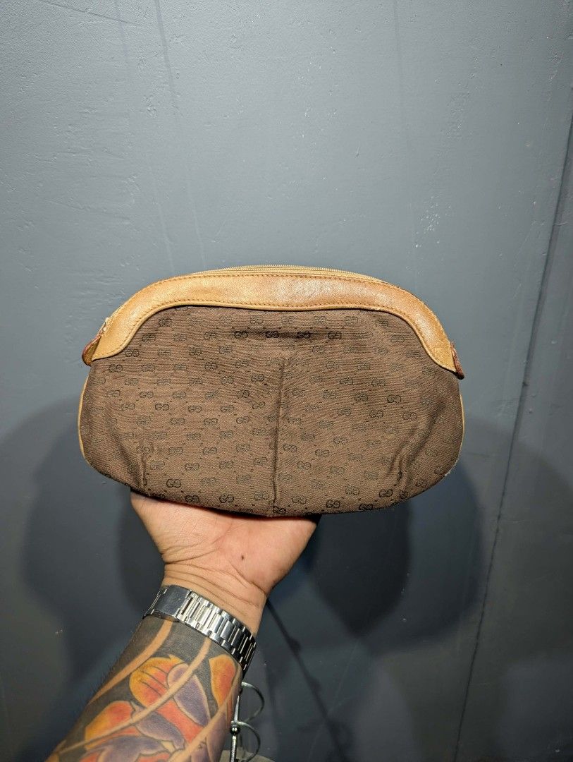 Gucci Monogram Clutch Bag (Category: Luxury Bags & Wallets) located in Manila. Submitted by roblesniks33584 (Listing ID 1458255651, Image 2). Description: - Vintage Gucci clutch - Classic GG monogram pattern - Tan leather trim and details - Zipper closure - Interior serial number present - Ideal for collectors.