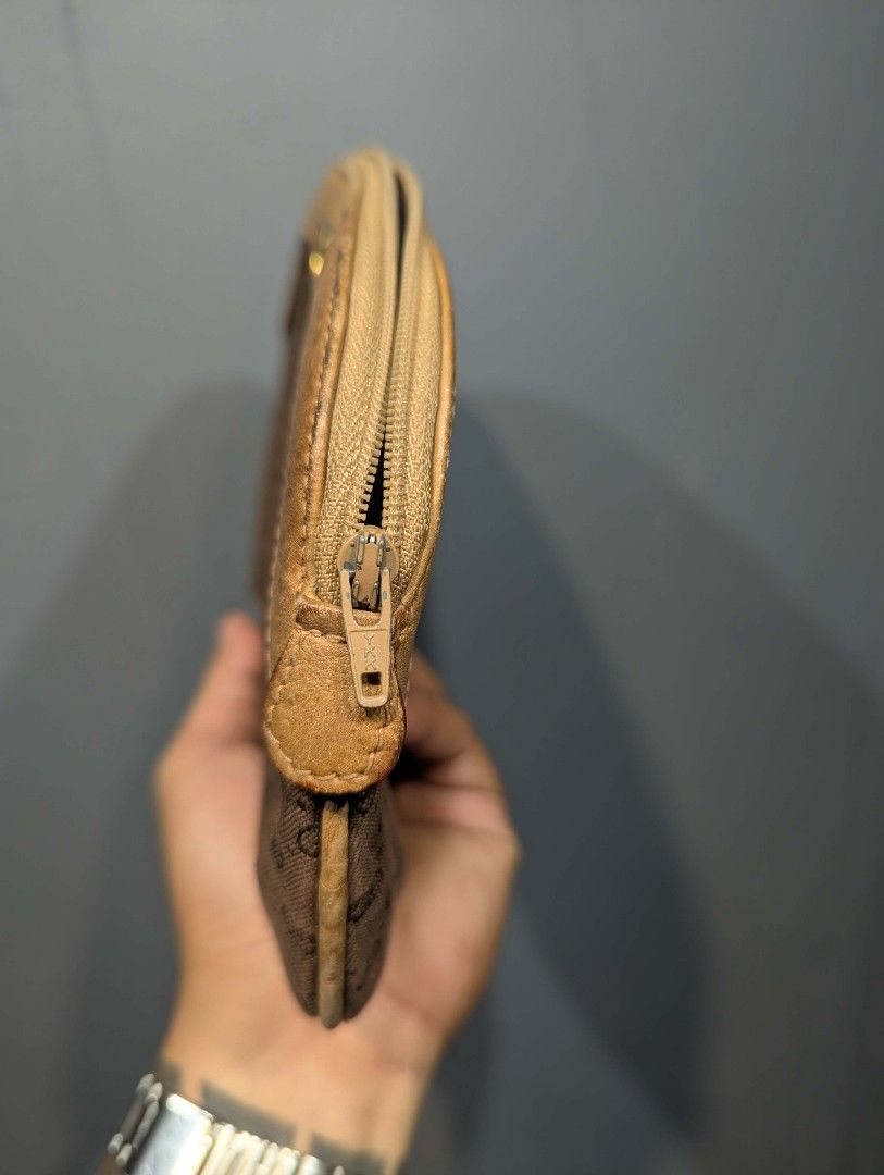 Gucci Monogram Clutch Bag (Category: Luxury Bags & Wallets) located in Manila. Submitted by roblesniks33584 (Listing ID 1458255651, Image 3). Description: - Vintage Gucci clutch - Classic GG monogram pattern - Tan leather trim and details - Zipper closure - Interior serial number present - Ideal for collectors.