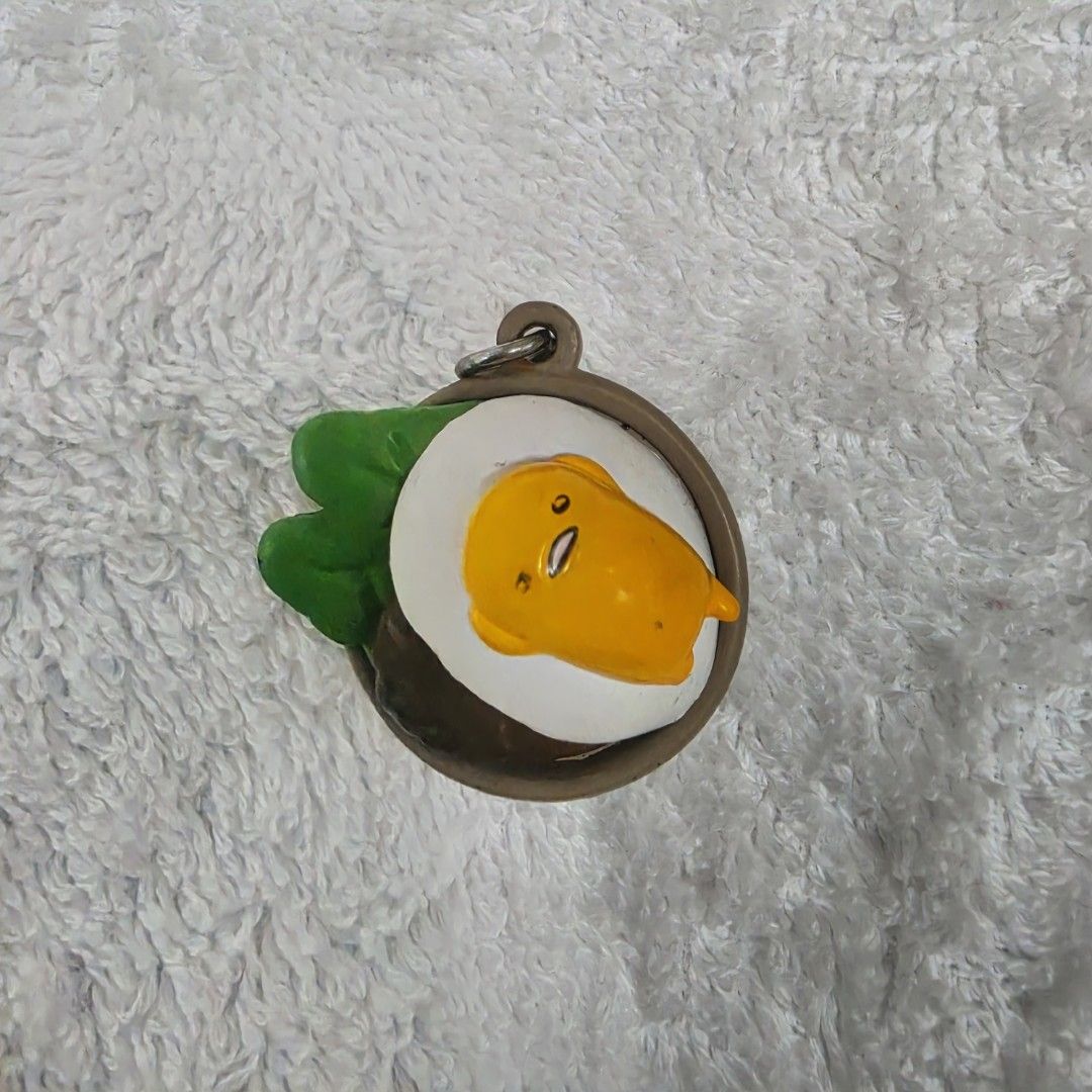 Gudetama Lazy Egg Charm (Category: Designer & Blind Box Toys) located in Pasig City. Submitted by aerasdrafts (Listing ID 1458285080, Image 1). Description: This capsule toy figure is Gudetama, the famously lazy egg character created by Sanrio..