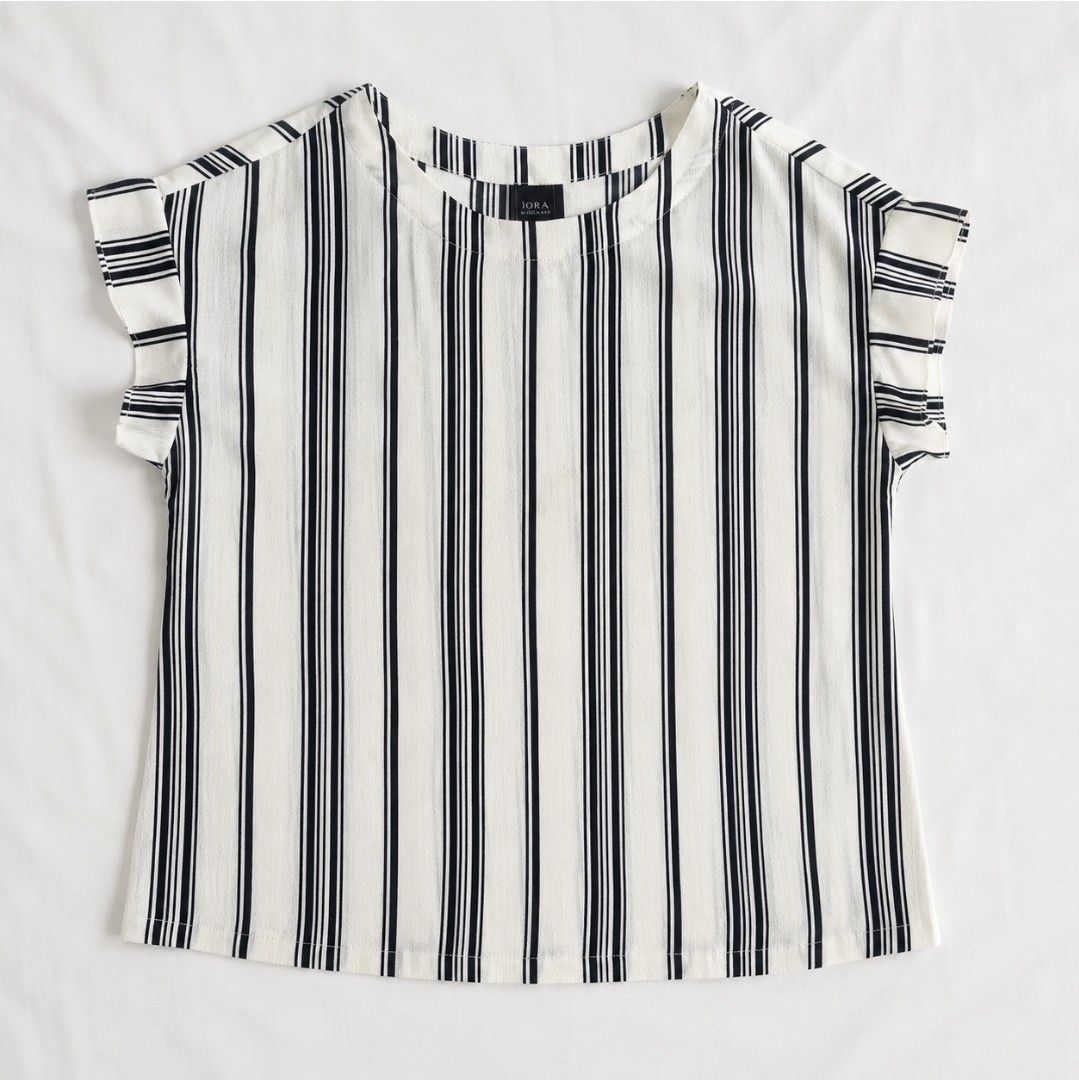 IORA Striped Cap Sleeve Top (Category: Blouses) located in Manila. Submitted by cinmowrol (Listing ID 1458154193, Image 1). Description: Best fit: L-XL Bust: 38" Length: 22" - Classic white top with black vertical stripes - Cap sleeves with ruffled detail - Simple and timeless design - Versatile for casual or dressed-up occasions - Effortlessly pairs with any bottoms.