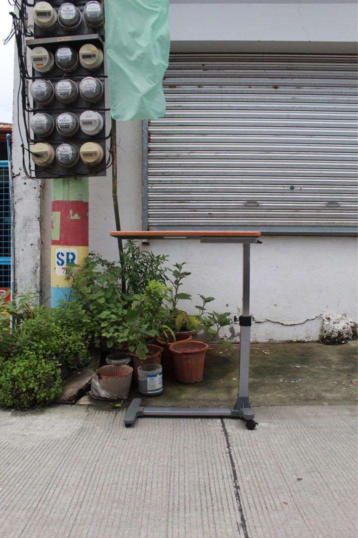 Japan Adjustable Mobile Overbed Table 🇯🇵 (Category: Other Home Furniture) located in San Fernando. Submitted by juls.japan.surplus (Listing ID 1458269116, Image 3). Description: Adjustable Mobile Overbed Table Adjustable mobile overbed table with a height-adjustable column, spacious wood-grain tabletop and smooth-rolling caster base. Perfect for use as a bedside table, laptop desk, reading table or work surface L:30 • W:15 • H:25 ½ up to 39 ½ i
