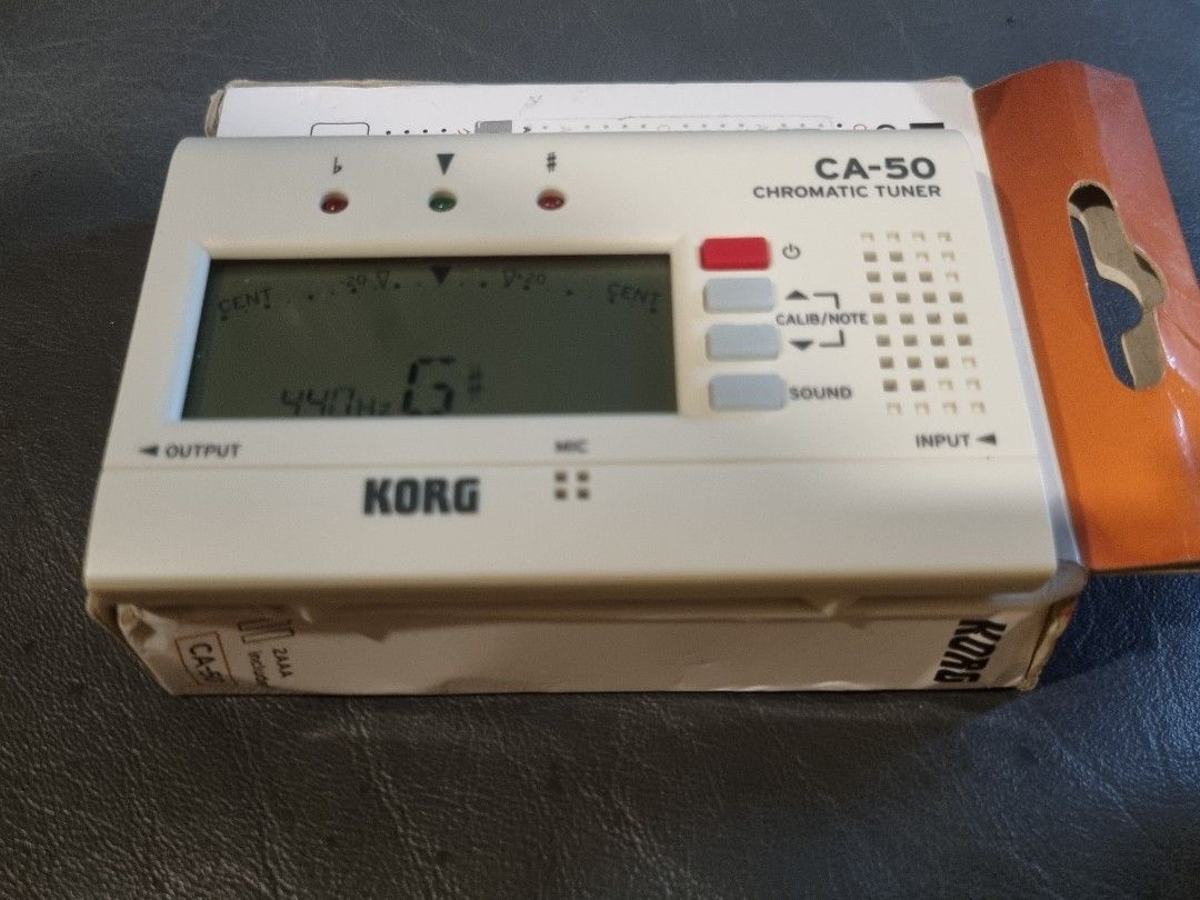 Korg CA-50 Chromatic Tuner (Category: Musical Instruments) located in Manila. Submitted by thrift.mercato (Listing ID 1458167537, Image 2). Description: With box Key Features Built-in Microphone: Detects acoustic notes without needing an external cable. Sound Out Mode: Plays an audible reference pitch through its internal speaker to help with ear training. Input/Output Jacks: Features standard 1/4" jacks if you want to plug in an instrument direc