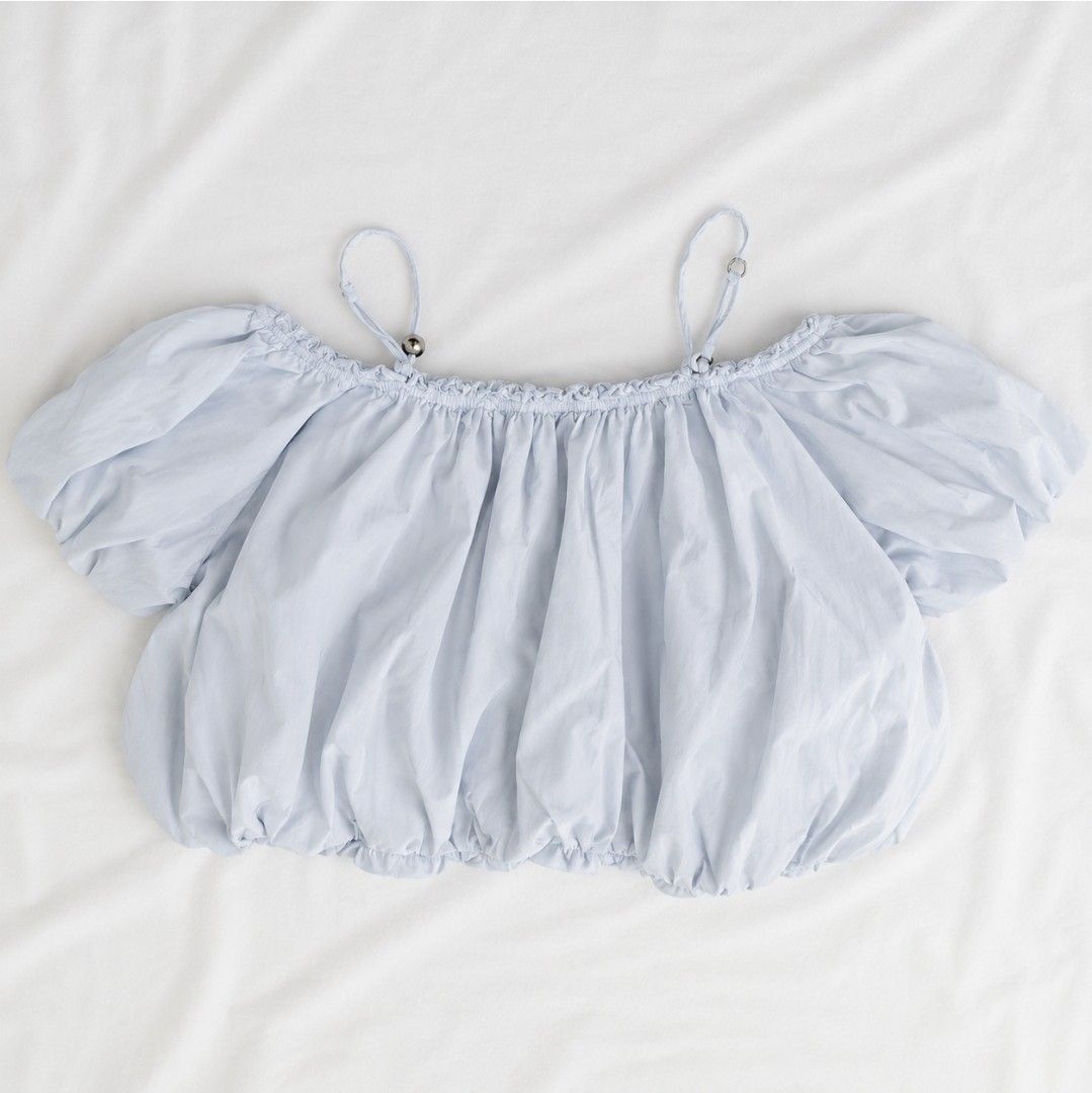 Light Blue Off-Shoulder Puff Sleeve Crop Top (Category: Blouses) located in Manila. Submitted by cinmowrol (Listing ID 1458153575, Image 1). Description: Best fit: S-M Bust:36" Length: 17" - Cute light blue crop top - Off-shoulder style with puff sleeves - Adjustable straps with silver details - Elasticated neckline and hem - Versatile for casual or beach looks - Pairs well with shorts or skirts.