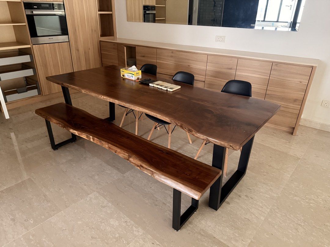 Live Edge Solid Suar Dining Table (Category: Tables & Sets) located in Singapore. Submitted by melatonin (Listing ID 1458154449, Image 1). Description: - Solid walnut live edge dining table and matching bench - bench and chairs sold separately for $100 - Natural wood grain - Sleek black metal base - Comfortable seating for 6-8 people - Ideal for modern or rustic dining spaces - Perfect for family meals and entertaining guests.