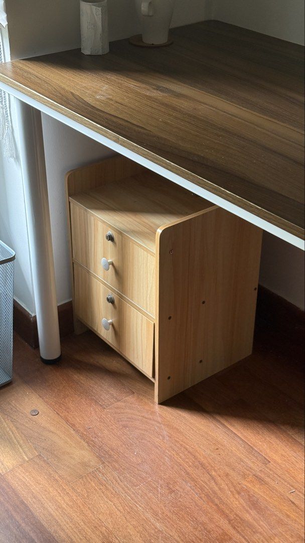 Lockable Side Table + Storage Unit (Category: Tables & Sets) located in Singapore. Submitted by dreascloset (Listing ID 1458170137, Image 1). Description: - Compact wooden drawer unit - Fits neatly under a desk - 4 drawers with simple handles + lockable - Light wood grain finish - Ideal for organizing stationery or small items - Helps keep your workspace tidy also works as a side table.