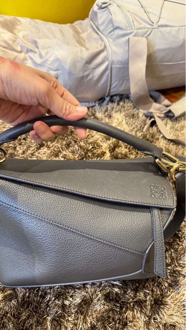 Loewe Grey Leather Puzzle Bag (Category: Luxury Bags & Wallets) located in Marikina City. Submitted by fashionart (Listing ID 1458211893, Image 1). Description: loewe puzzle bag gold hardware 2024 excellent condition looks brand new complete inclusions with dustbag and card bought in loewe Coppenhagen Airport september 2024 .