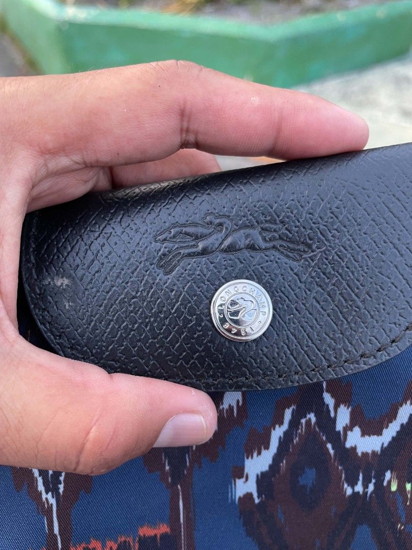 Longchamp Paris Pouch Bag with Ikat Print (Category: Luxury Bags & Wallets) located in Polomolok. Submitted by warmfire.3185dd (Listing ID 1458270757, Image 2). Description: - Authentic Longchamp Paris pouch bag - Unique ikat-inspired print - Black leather trim and strap - Zipper closure with branded pull - Made in France - Ideal for carrying essentials.