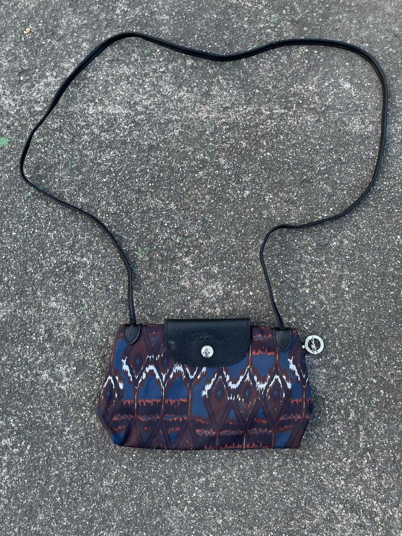 Longchamp Paris Pouch Bag with Ikat Print (Category: Luxury Bags & Wallets) located in Polomolok. Submitted by warmfire.3185dd (Listing ID 1458270757, Image 1). Description: - Authentic Longchamp Paris pouch bag - Unique ikat-inspired print - Black leather trim and strap - Zipper closure with branded pull - Made in France - Ideal for carrying essentials.
