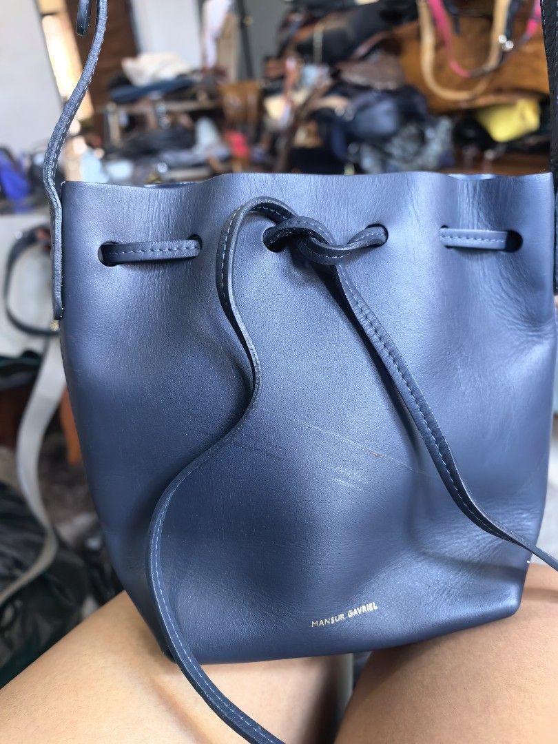 Mansur Gavriel Navy Leather Bucket Bag (Category: Luxury Bags & Wallets) located in Cagayan de Oro. Submitted by tommygurl1218 (Listing ID 1458108193, Image 1). Description: - Authentic Mansur Gavriel navy blue leather bucket bag - Secure drawstring closure - Adjustable shoulder strap with elegant gold-tone hardware - Classic, minimalist design - Ideal for everyday wear and tear With minimal sign of use .