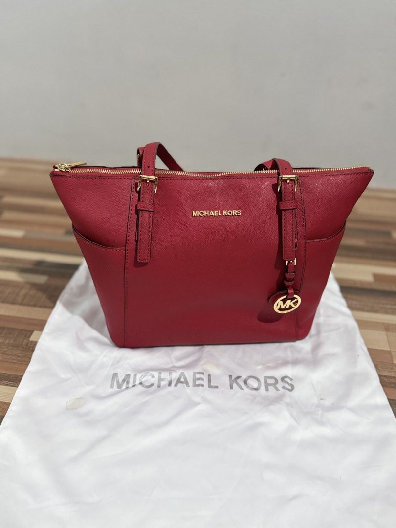 Michael Kors Red Leather Tote Bag (Category: Luxury Bags & Wallets) located in Quezon City. Submitted by clarakels (Listing ID 1458173221, Image 2). Description: - Classic red leather tote from Michael Kors - Elegant gold hardware details - Convenient side pockets for easy access - Includes original dust bag - Ideal everyday bag.