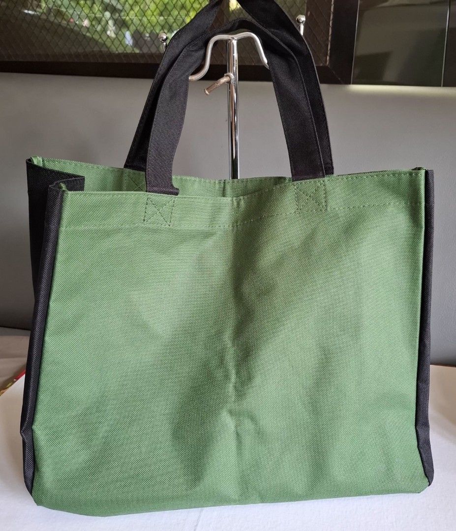 Miffy Green Tote Bag with Giraffe Pockets (Category: Tote Bags) located in Don Carlos. Submitted by PphiXi_Finds (Listing ID 1458251539, Image 2). Description: Cute green tote bag featuring Miffy and two giraffes. Has front pockets for easy access. Great for shopping or carrying everyday essentials. Handles are black and sturdy. Measures about 15 inches wide..