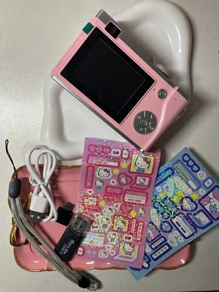Pink Hello Kitty Digital Camera with Stickers and Accessories (Category: Cameras) located in Manila. Submitted by girliesglam (Listing ID 1458182022, Image 1). Description: - Cute pink digital camera - Includes USB cable - Includes SD card reader - Comes with Kitty stickers (two sheets, pink & blue, holographic) - Great for taking fun photos - Perfect for Kitty fans.