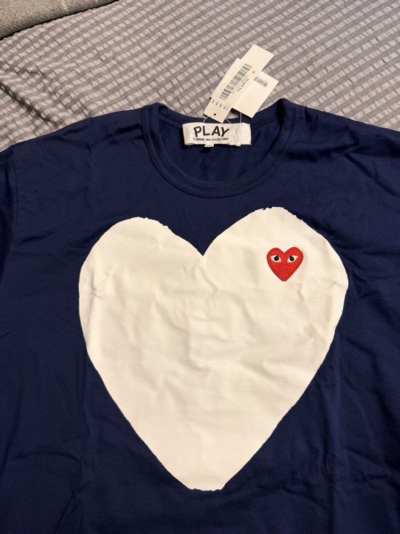 Play CDG Comme des Garcons (Category: Tshirts & Polo Shirts ) located in Pasig City. Submitted by donmsamson (Listing ID 1458269482, Image 3). Description: - Brand: Play CDG Comme des Garcons - Color: Navy Blue - Size: XXL - Design: Iconic heart logo with red eyes and large white heart graphic - Condition: Brand New - Style: Streetwear, casual.