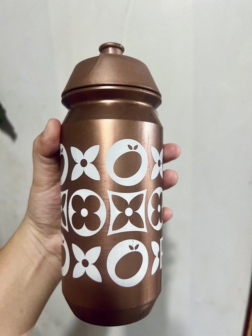 Pop Cycling Co Bronze Water Bottle (Category: Water Bottles & Tumblers) located in Taytay. Submitted by dezaaaa (Listing ID 1458296438, Image 3). Description: - Bronze water bottle with a fun white pattern. - Features a secure screw-on lid with a convenient pull-up spout. - Made of durable plastic, perfect for hydration on the go. - Bottom has markings, including 'wash before use'..