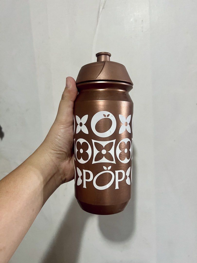 Pop Cycling Co Bronze Water Bottle (Category: Water Bottles & Tumblers) located in Taytay. Submitted by dezaaaa (Listing ID 1458296438, Image 1). Description: - Bronze water bottle with a fun white pattern. - Features a secure screw-on lid with a convenient pull-up spout. - Made of durable plastic, perfect for hydration on the go. - Bottom has markings, including 'wash before use'..