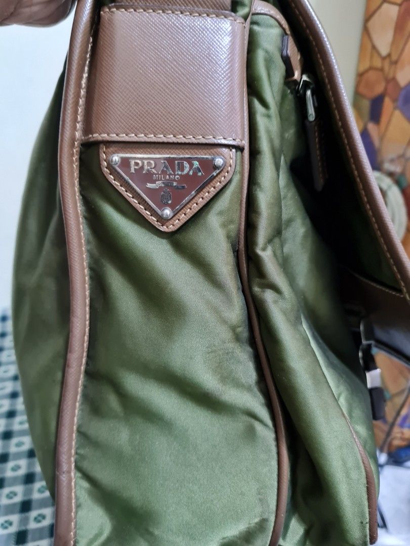 Prada (Category: Luxury Bags & Wallets) located in Bulacan. Submitted by kraeyon_shop (Listing ID 1458125327, Image 3). Description: 💯 Guaranteed authentic Prada Saffiano Trimmed Tessuto Double Buckle Messenger Bag. Material: Crafted from durable Tessuto nylon body with signature Saffiano leather trim. Color: Distinctive olive green / khaki body paired with a brown adjustable flat webbed shoulder strap and matching brown trim..