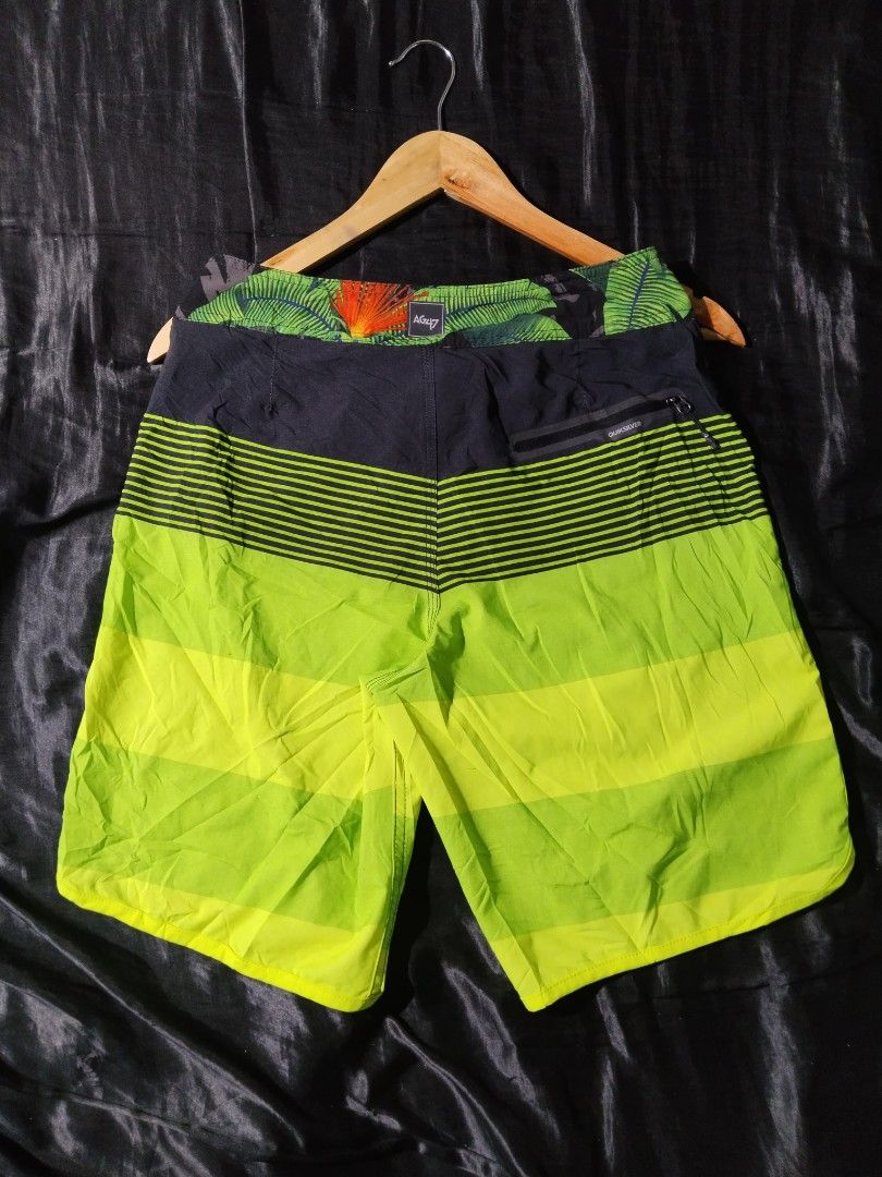 Quiksilver Board Shorts - Dry Flight Technology (Category: Shorts) located in Digos. Submitted by kyle_curation.ph (Listing ID 1458229517, Image 2). Description: - Quiksilver board shorts - 28×18 Dimension - Dry Flight technology - Tropical leaf print waistband - Bold striped leg pattern - Color: Bright lime green and black - Lace-up front closure - Small zip pocket on the back - Ideal for swimming or surfing.