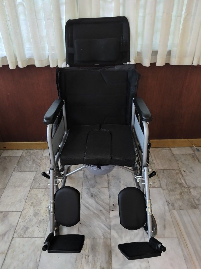 Reclining Wheelchair with Commode Seat (Category: Wheelchairs) located in Manila. Submitted by newmoon-e25b (Listing ID 1458266852, Image 2). Description: - Comfortable reclining backrest and headrest - Removable commode seat for convenience - Padded armrests for comfort - Adjustable footrests for a personalized fit - Large rear wheels for stability and maneuverability - Excellent mobility assistance.