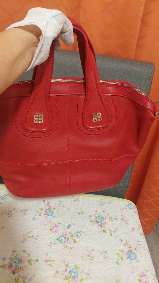 Red Givenchy Leather Tote Bag (Category: Luxury Bags & Wallets) located in Paranaque City. Submitted by daddyu (Listing ID 1458170199, Image 2). Description: - Genuine red leather tote bag - Iconic Givenchy logo hardware - Secure zipper closure - Comfortable top handles - Generous size: approximately 16 inches wide - Ideal for everyday use with ample interior space Free Givenchy Lucky Charm.