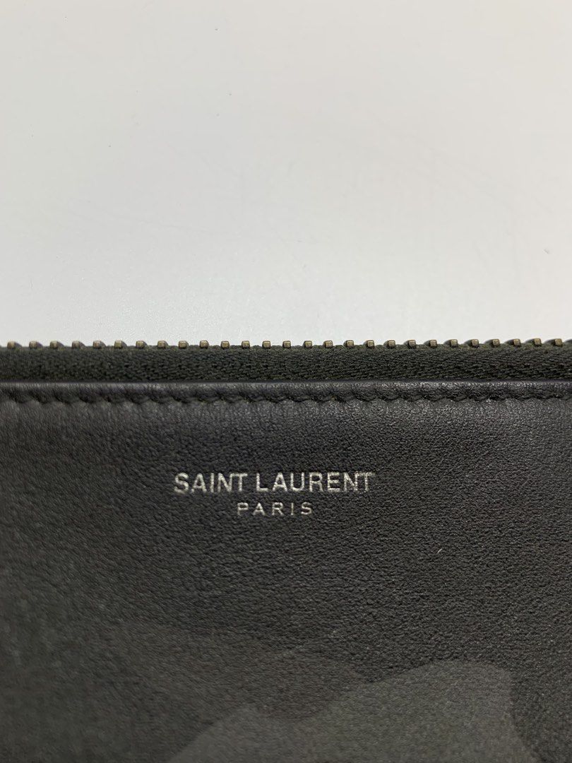 Saint Laurent - camouflage clutch bag (Category: Belt bags, Clutches and Pouches) located in Manila. Submitted by shottas_21 (Listing ID 1458219160, Image 2). Description: Saint Laurent - camouflage clutch bag CONDITION - 8.5/10 Flaw - Press marks, signs of usage DM ME FOR MORE PICTURE - Dimensions (INCH) Height - 10” Width - 14.5”.