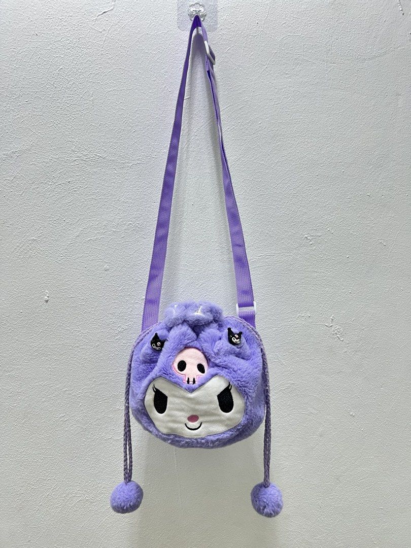 Sanrio Kuromi plush drawstring crossbody bag (Category: Diaper Bags & Wetbags) located in Imus. Submitted by vdc.apparel (Listing ID 1458131513, Image 1). Description: This is fluffy purple Sanrio Kuromi plush drawstring crossbody bag with embroidered facial features and pom-pom pull strings.