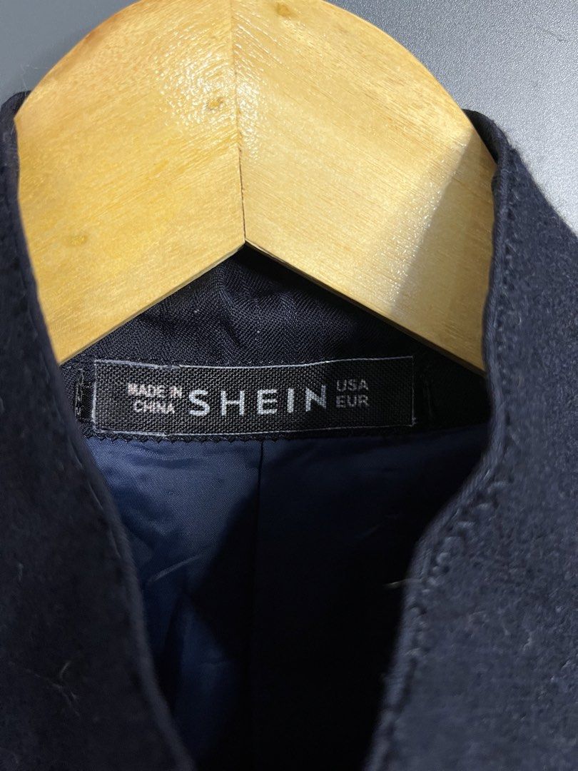 SHEIN Navy Striped Blazer for Men (Category: Coats, Jackets and Outerwear) located in Angeles City. Submitted by mochimochi1219 (Listing ID 1458152978, Image 2). Description: - Navy blazer from SHEIN - Subtle vertical stripe pattern - Two-button front closure - Two front flap pockets - Button details on cuffs - Standard fit - Ideal for smart casual outfits.