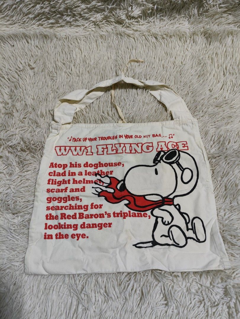 Snoopy WW1 Flying Age Canvas Tote Bag (Category: Tote Bags) located in Lucena. Submitted by cha_riz010726 (Listing ID 1458216668, Image 1). Description: - Adorable Snoopy tote bag with a fun WWI flying theme. - Features Snoopy dressed as a pilot. - Includes an interior pocket for organization. - Perfect for carrying your daily essentials. - Shows some signs of use, but remains in good, usable condition..