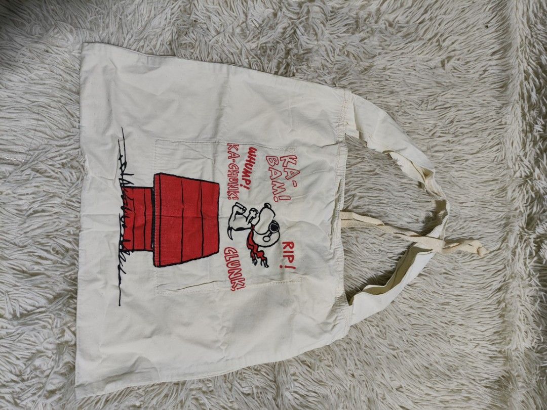 Snoopy WW1 Flying Age Canvas Tote Bag (Category: Tote Bags) located in Lucena. Submitted by cha_riz010726 (Listing ID 1458216668, Image 2). Description: - Adorable Snoopy tote bag with a fun WWI flying theme. - Features Snoopy dressed as a pilot. - Includes an interior pocket for organization. - Perfect for carrying your daily essentials. - Shows some signs of use, but remains in good, usable condition..