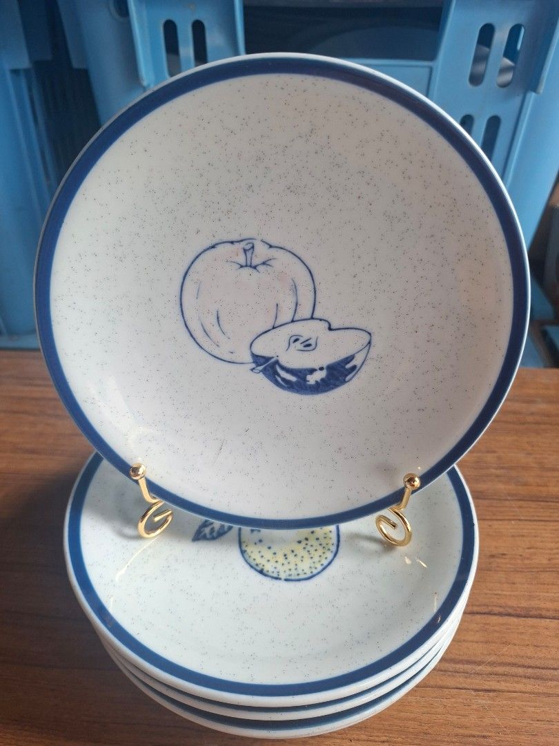 Speckled Ceramic Plates set of 5 (Category: Dinnerware & Cutlery) located in Consolacion. Submitted by luxekerei (Listing ID 1458171204, Image 1). Description: - stack of white ceramic speckled plates featuring a blue rim and a blue-and-white apple illustration. - 16cm in diameter..