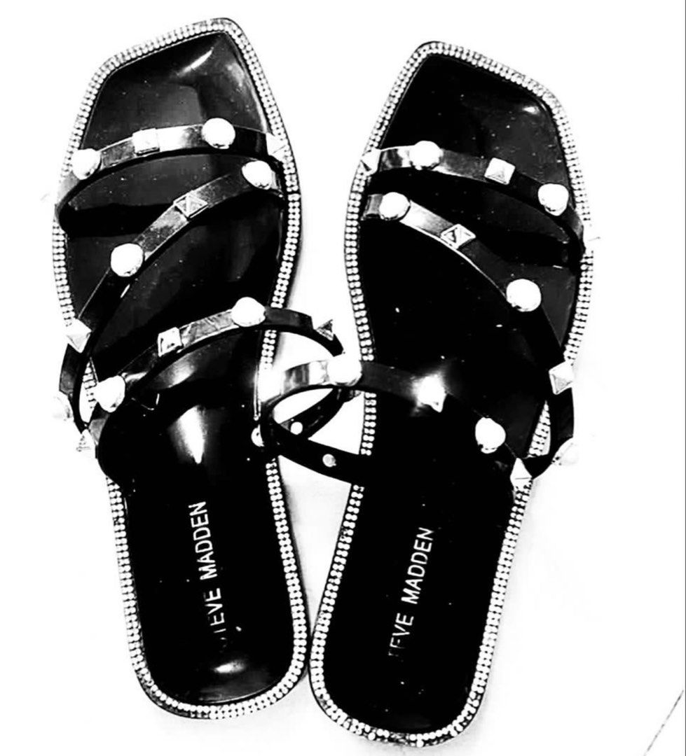 Steve madden sandals (Category: Flats & Sandals) located in Manila. Submitted by bornthisway22 (Listing ID 1458203420, Image 1). Description: Black Steve Madden sandals with studded details. Features a square toe design and clear straps. The sandals have a rhinestone trim around the edges. The brand name is visible on the insole. Actual Picture poster.
