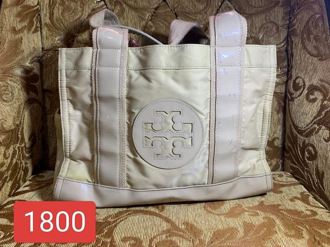 Tory Burch Nylon Tote Bag (Category: Luxury Bags & Wallets) located in Manila. Submitted by jiainah (Listing ID 1458290972, Image 1). Description: - Cream colored Tory Burch tote bag - Features signature Tory Burch logo on the front - Patent leather handles - Minor scuffs on patent handles - Slight discoloration on the bottom edge - Great for everyday use.