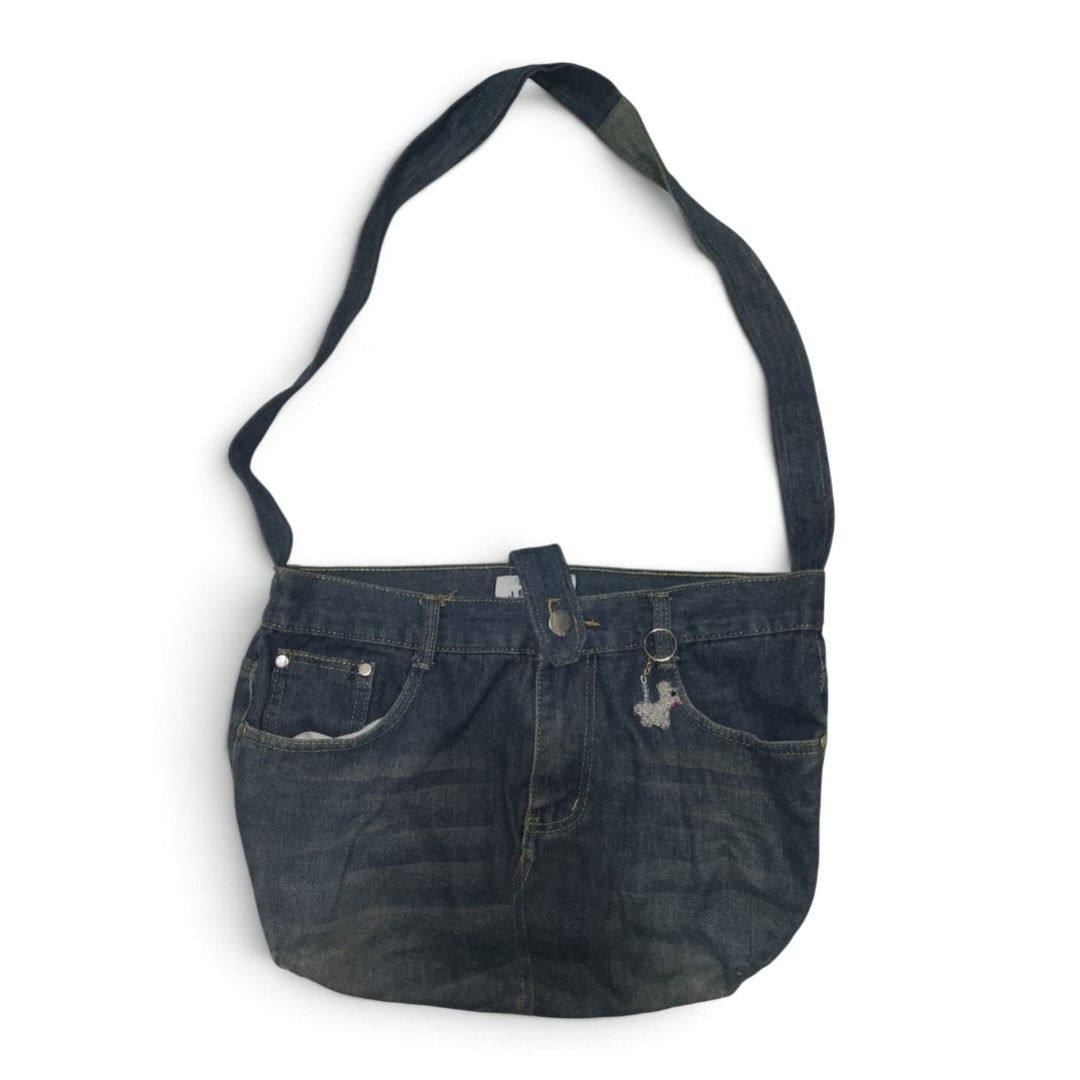 Upcycled Denim Jeans Shoulder Bag (Category: Shoulder Bags) located in Cabuyao City. Submitted by cozieee.eee (Listing ID 1458274225, Image 1). Description: - Made from actual denim jeans - Features original pockets and belt loops - Comes with a cute poodle charm - Adjustable strap for comfort - Ideal for casual wear - Unique and stylish piece.
