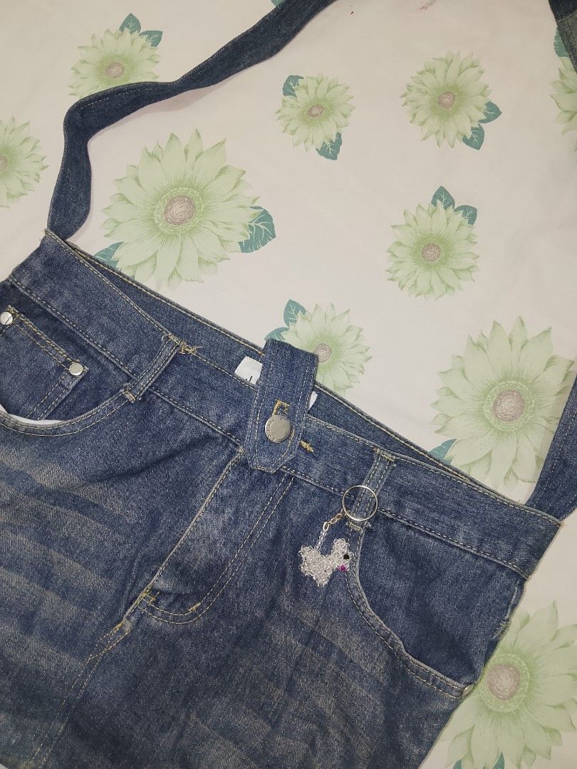 Upcycled Denim Jeans Shoulder Bag (Category: Shoulder Bags) located in Cabuyao City. Submitted by cozieee.eee (Listing ID 1458274225, Image 2). Description: - Made from actual denim jeans - Features original pockets and belt loops - Comes with a cute poodle charm - Adjustable strap for comfort - Ideal for casual wear - Unique and stylish piece.