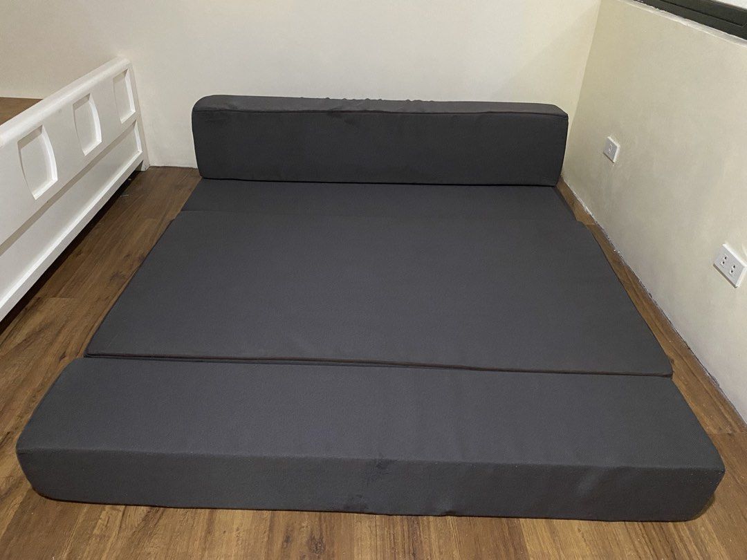 Uratex Dark brown queen sized Folding Foam Mattress / Sofa Bed (Category: Bed Frames & Mattresses) located in Mandaluyong City. Submitted by minimalist_mak (Listing ID 1458237943, Image 3). Description: - Dark grey folding mattress - Versatile: Use as a mattress or a sofa - Folds out to a large sleeping surface - Comfortable foam padding - Ideal for guests or small living spaces - Easy to store when not in use.