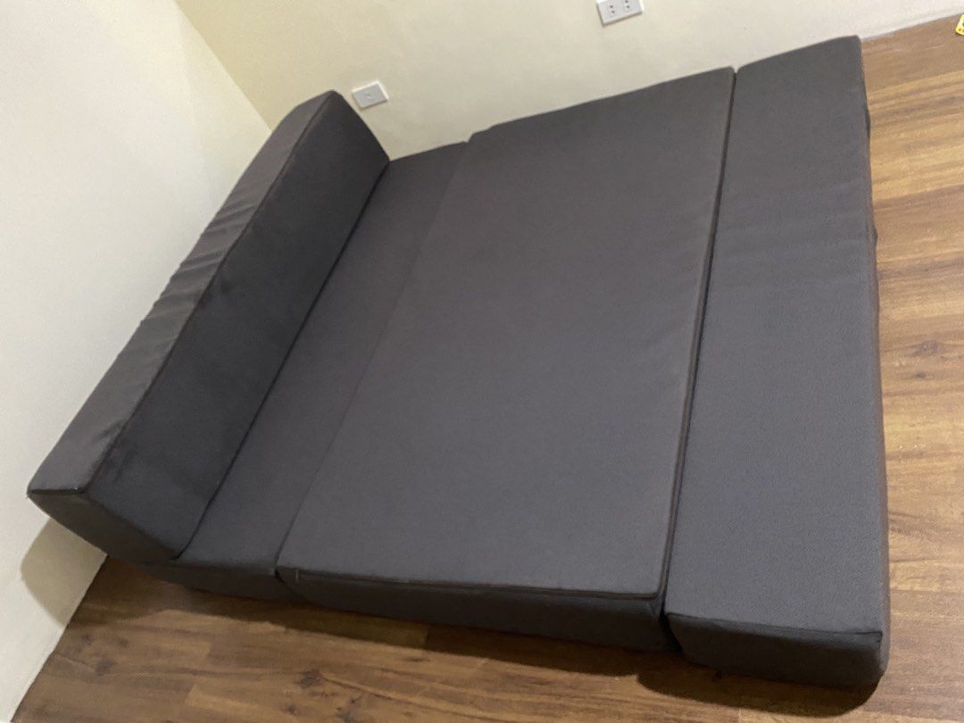 Uratex Dark brown queen sized Folding Foam Mattress / Sofa Bed (Category: Bed Frames & Mattresses) located in Mandaluyong City. Submitted by minimalist_mak (Listing ID 1458237943, Image 2). Description: - Dark grey folding mattress - Versatile: Use as a mattress or a sofa - Folds out to a large sleeping surface - Comfortable foam padding - Ideal for guests or small living spaces - Easy to store when not in use.