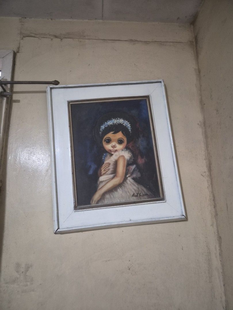 Vintage "Big Eyes" Painting - Signed (Category: Art & Prints) located in Marikina City. Submitted by jillianmendoza28 (Listing ID 1458294597, Image 2). Description: - Framed painting of a child with distinctive large eyes. - Artist signature on the right side. - Classic white frame. - Adds a unique touch to any room. - Ready to hang..