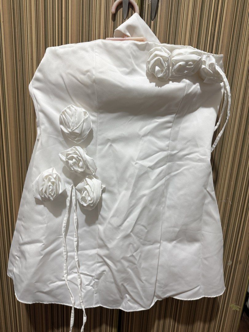 White Halter Dress with Rose (Category: Dresses) located in Manila. Submitted by chie04_875 (Listing ID 1458104448, Image 2). Description: - White strapless dress - Features a halter neckline - Adorned with rose embellishments on the bodice - Adjustable tie details on the sides for a custom fit - Short length -Never been used - Ideal for parties and events.