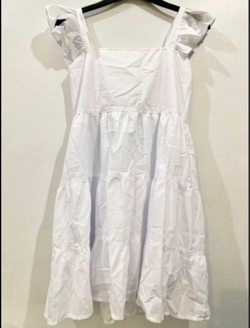 White Tiered Square Neck Mini Dress with Flutter Sleeves (Category: Dresses) located in Quezon City. Submitted by decluttering_alot (Listing ID 1458117349, Image 3). Description: - Actual when worn posted - Cute white mini dress - Square neckline with flutter sleeves - Tiered skirt design - Ideal for casual outings or beach days - Versatile styling with sandals or sneakers Brand: Shop nita RFS Closet Cleanup.