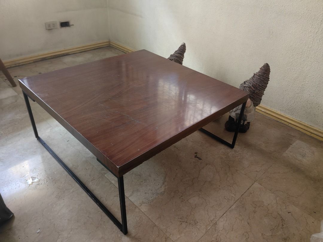 Wooden Coffee Table with Black Metal Frame (Category: Tables & Sets) located in Manila. Submitted by clevertree.70f0b5 (Listing ID 1458219883, Image 2). Description: - Square coffee table with a chic dark wood finish. - Features a sleek and sturdy black metal frame. - Tabletop boasts a beautiful sheen..