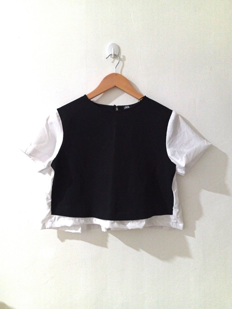 Zara Black and White Cropped Top (Category: Blouses) located in Manila. Submitted by cococlo_ (Listing ID 1458168025, Image 1). Description: - Zara cropped top - Black front panel with white short sleeves and hem - Simple and chic design - Ideal for casual outings or dressing up - Easily pairs with skirts or pants.