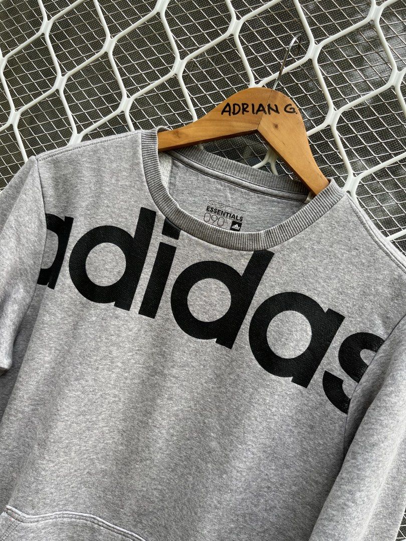 Adidas Essentials Grey Crewneck Sweatshirt (Category: Coats, Jackets and Outerwear) located in Panaon. Submitted by adrian_galope. (Listing ID 1458312247, Image 2). Description: - Grey Adidas sweatshirt - Large black logo on the front - Front pocket - Made with Essentials material - Ideal for casual wear - Comfortable and stylish.