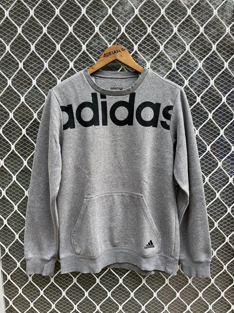 Adidas Essentials Grey Crewneck Sweatshirt (Category: Coats, Jackets and Outerwear) located in Panaon. Submitted by adrian_galope. (Listing ID 1458312247, Image 1). Description: - Grey Adidas sweatshirt - Large black logo on the front - Front pocket - Made with Essentials material - Ideal for casual wear - Comfortable and stylish.