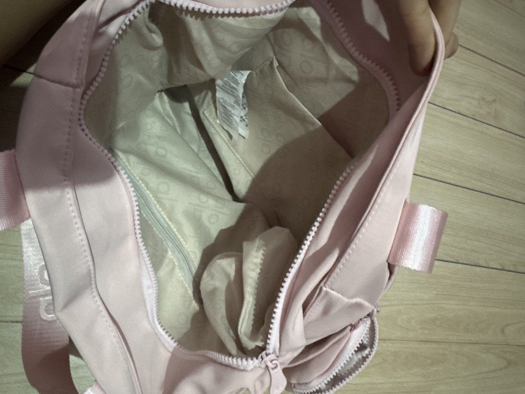 alo pink bag with pouch (Category: Luxury Bags & Wallets) located in Malabon City. Submitted by nanayinah (Listing ID 1458316020, Image 3). Description: - can fit 14 inch laptop - front zip and no-zip pocket - includes a small matching zip pouch (attached) - with extra straps - only used once in the office! - negotiable for sure buyers.