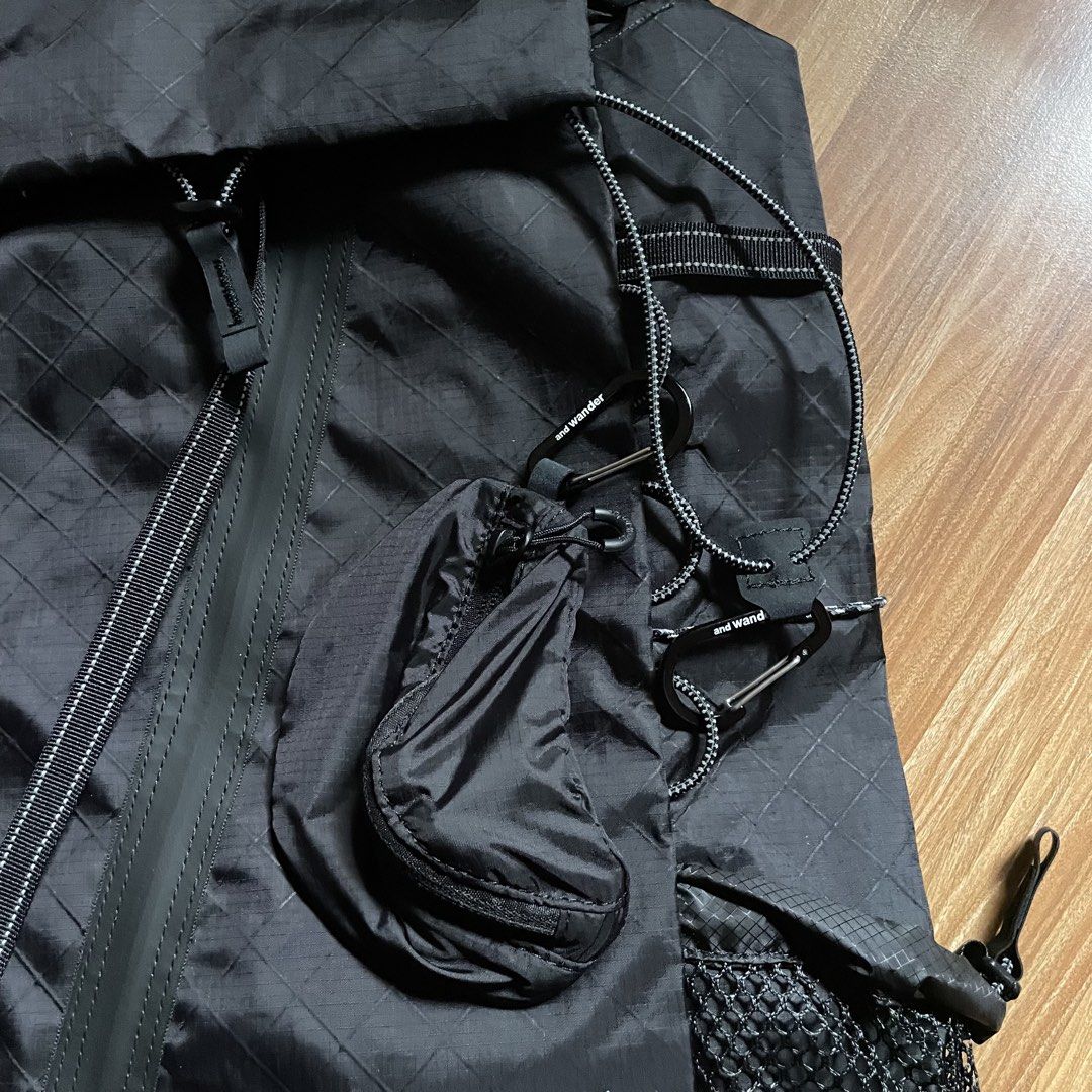 And Wander ECOPAK 30L Backpack - Black (Category: Backpacks) located in General Mariano Alvarez. Submitted by 4117_thriftnthrive (Listing ID 1458465756, Image 2). Description: Brand new condition No flaws The and wander ECOPAK 30L Backpack is shown here in black, constructed from water-resistant, recycled polyester with a distinct diamond grid pattern..