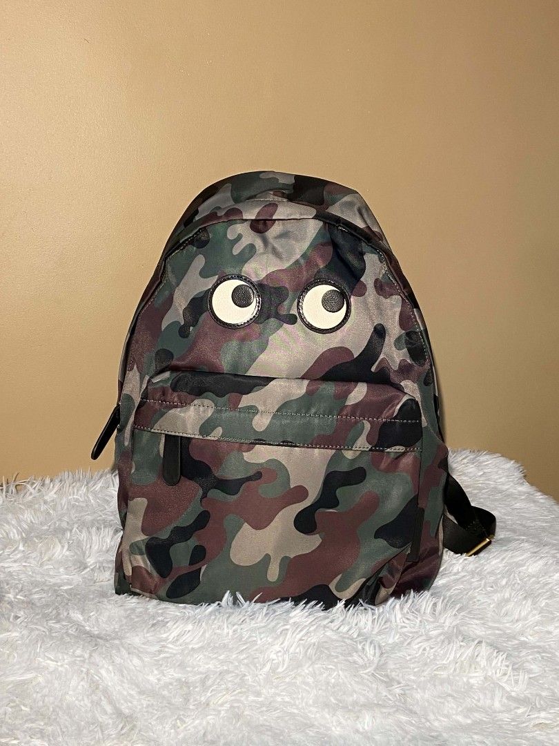 Anya Hindmarch Camouflage Eyes Backpack (Category: Babies & Kids Fashion) located in Bulacan. Submitted by bella.ken.varietystore (Listing ID 1458339167, Image 1). Description: Cute Anya Hindmarch backpack. Features a fun camouflage print with googly eyes on the front pocket. Made from 100% recycled nylon. Plenty of space inside with pockets for organization. Great for everyday use or travel..
